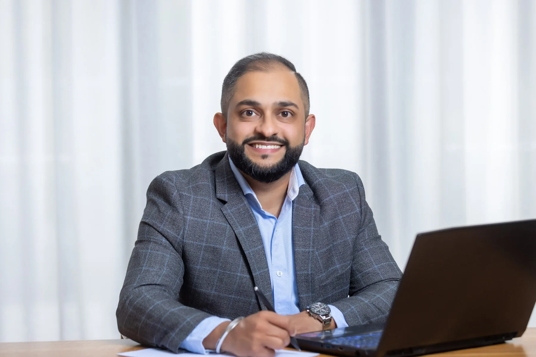 Manraj Singh reviewing client figures