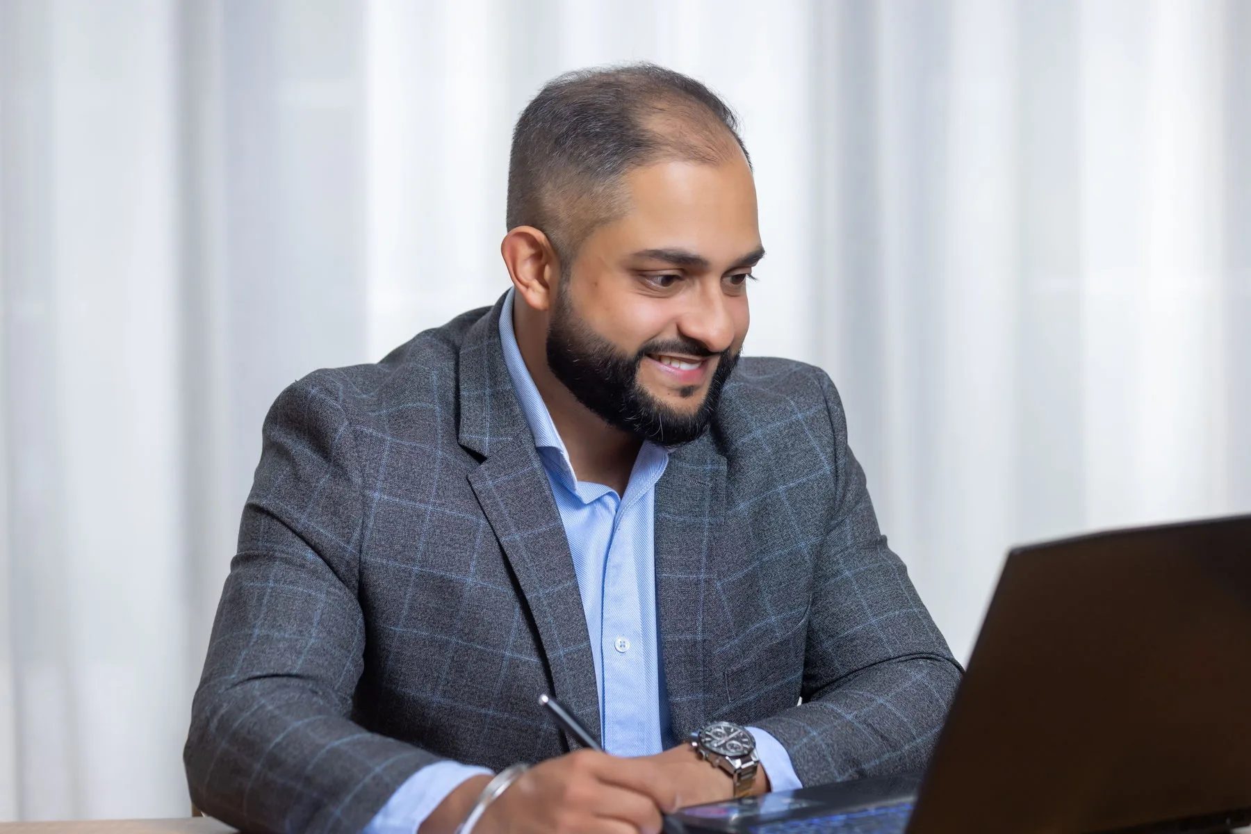 Manraj Singh preparing a client report