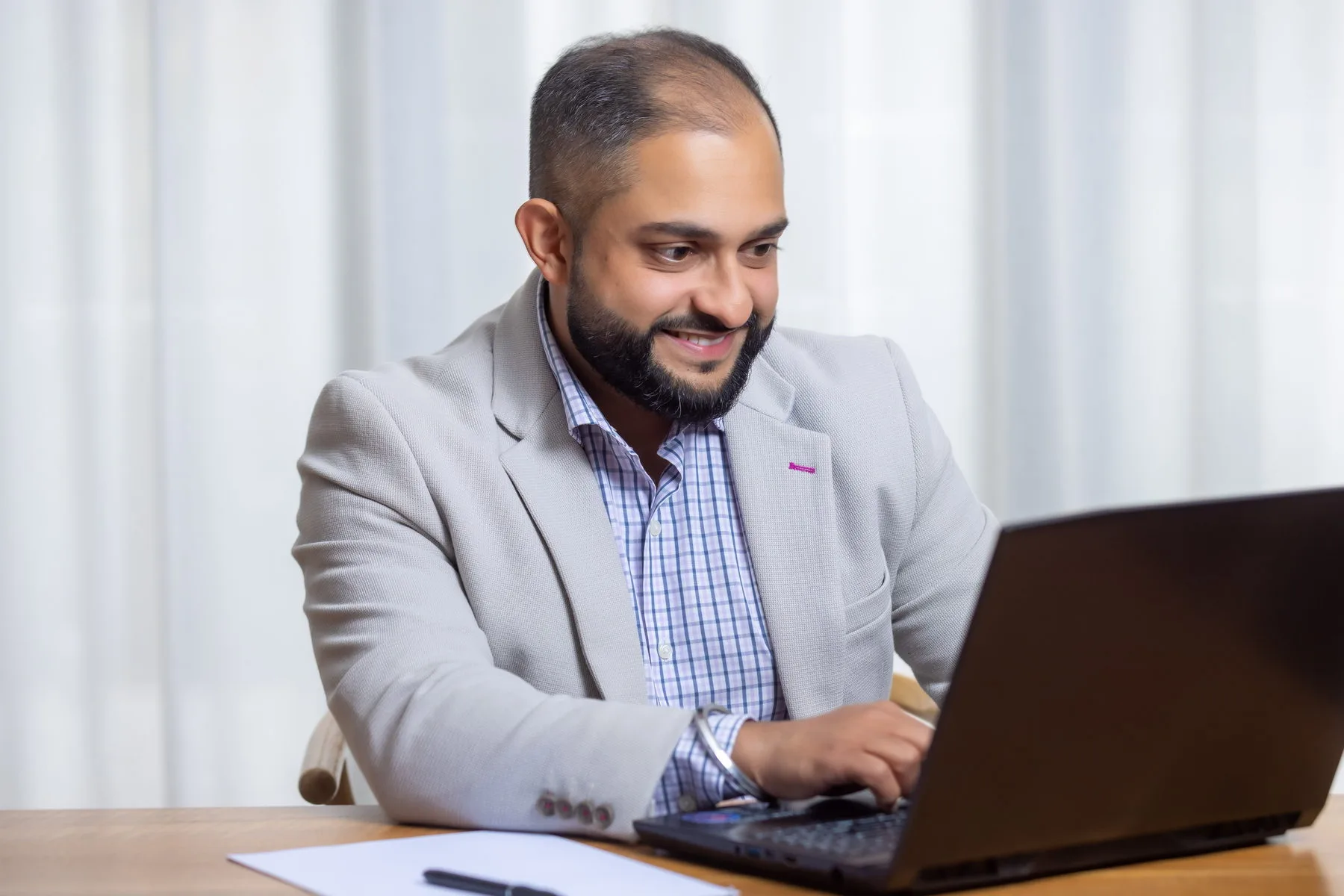 Manraj Singh at work on a client file