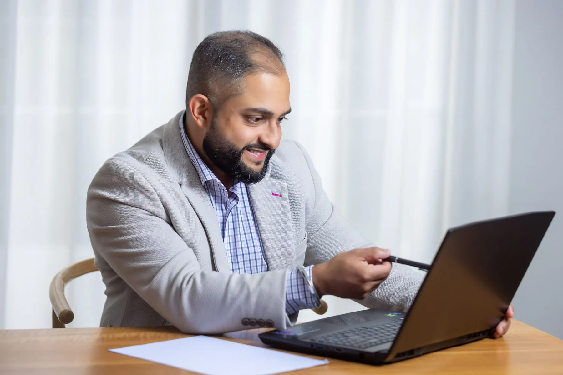 Manraj Singh reviewing figures on screen