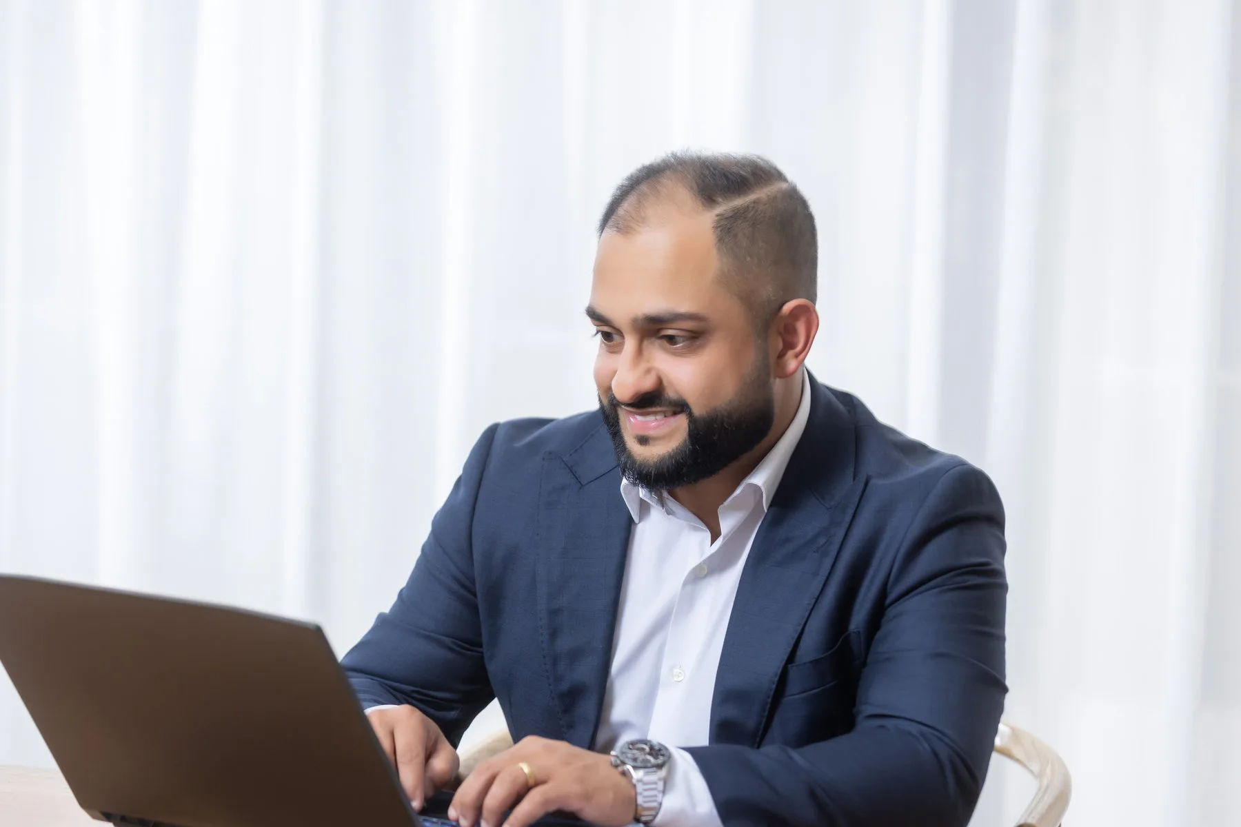 Manraj Singh working at his laptop