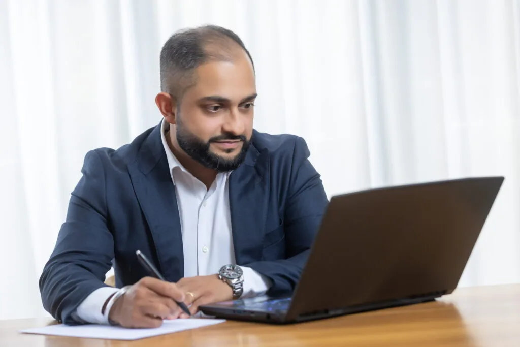 Manraj Singh, founder of SMA Business Advisory, reviewing figures at his desk
